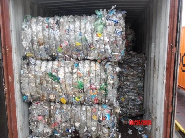 Bales of PET bottles stacked inside a shipping container