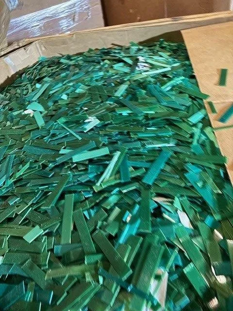 A box of chopped green PET strapping